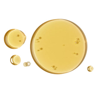 Gold-colored liquid droplets of my Geisha Cannabis Bath and Shower Gel on a white background