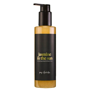 A bottle of My Geisha 'Jasmine in the Sun' hand and body wash, featuring a black pump dispenser, a black label with gold and white text, and a golden-yellow liquid visible through the clear bottle, set against a plain white background.