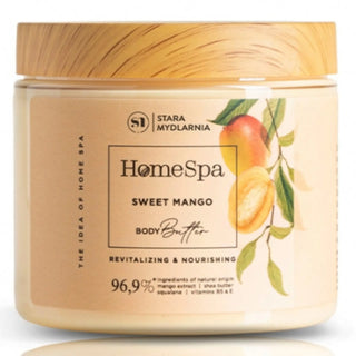 A jar of Stara Mydlarnia Mango Body Butter with a label showing the product name and a mango illustration. The jar is sealed with a wooden lid.