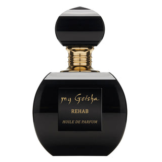 A black perfume bottle with a gold cap labeled 'my Geisha REHAB Huile de Parfum'.