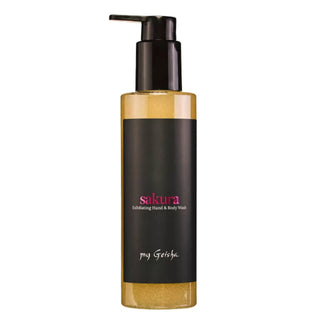 A bottle of my Geisha Sakura exfoliating hand & body wash, featuring a black pump dispenser, a black label with pink and white text, and a golden-yellow exfoliating liquid visible through the clear bottle, set against a plain white background.