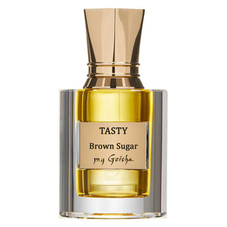 A bottle of Tasty Brown Sugar fragrance by my Geisha with a clear golden liquid and a gold-colored cap.